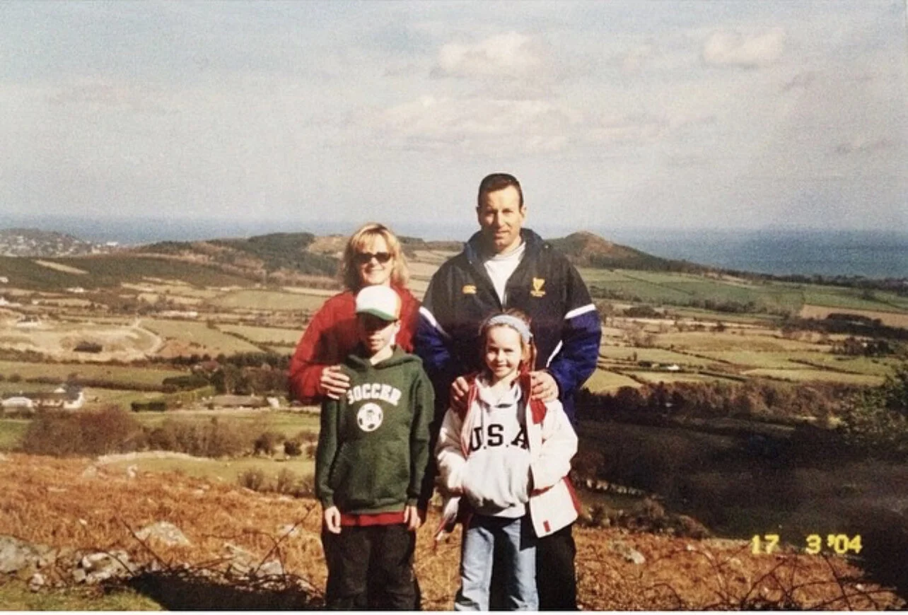 A family of four standing on a green hillside in Ireland, dated 2004