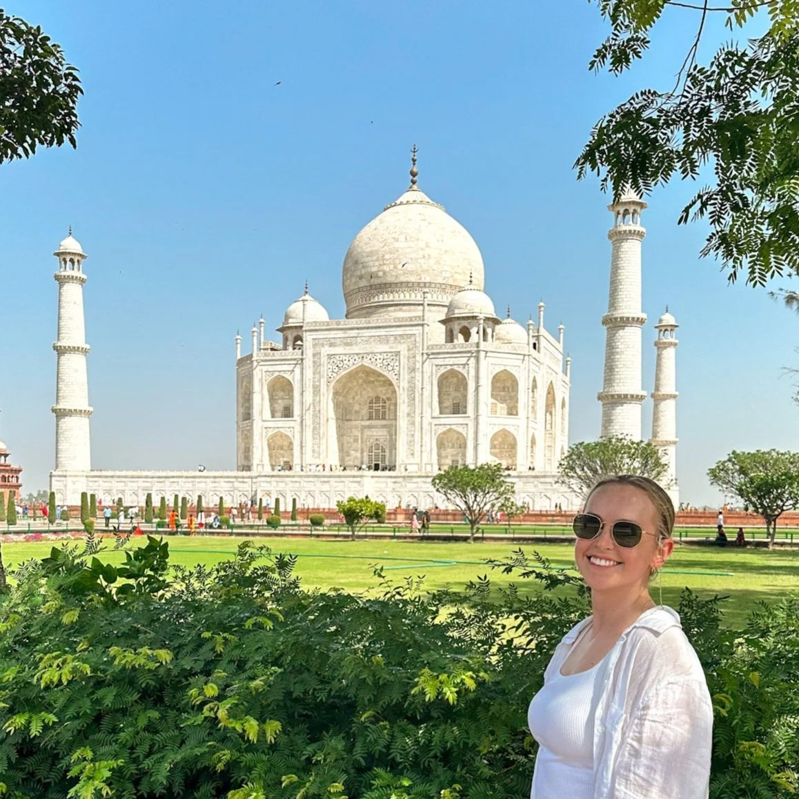 Nicole in sunglasses standing in the gardens in front of the Taj Mahal